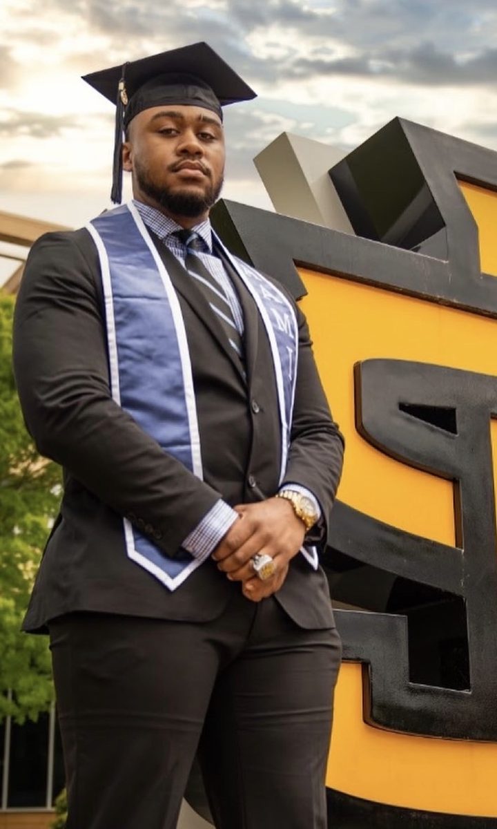 Devin in cap and gown at Kennesaw State University